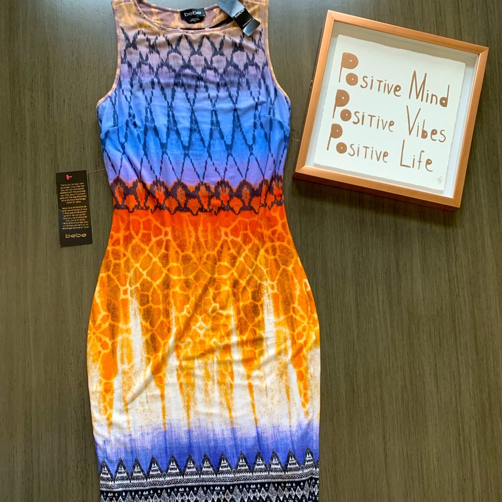 Hip hugging Bebe dress with woven cut up back.